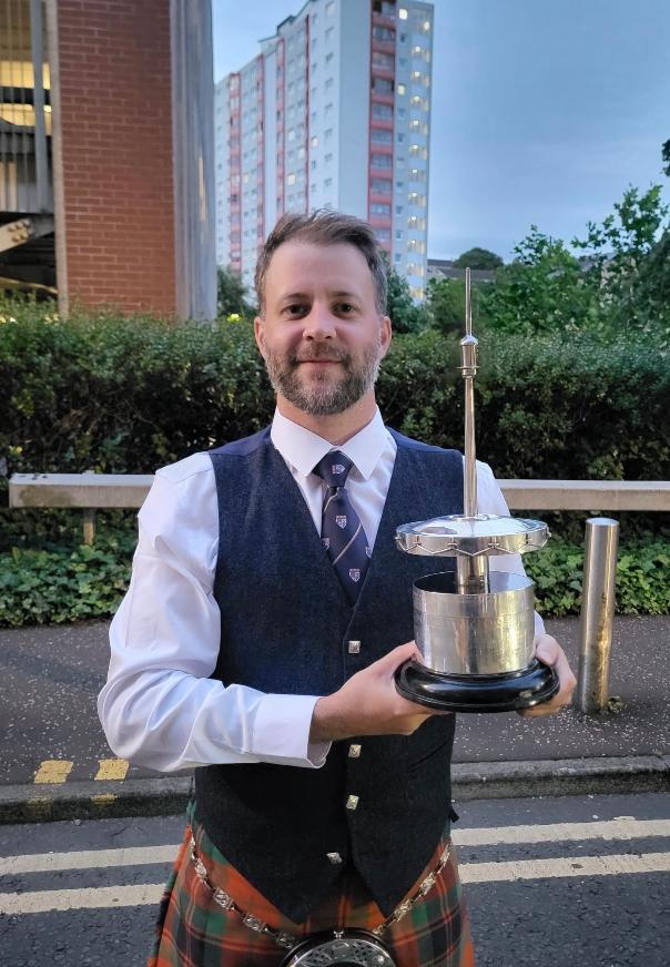 Alastair Lee with a piping trophy